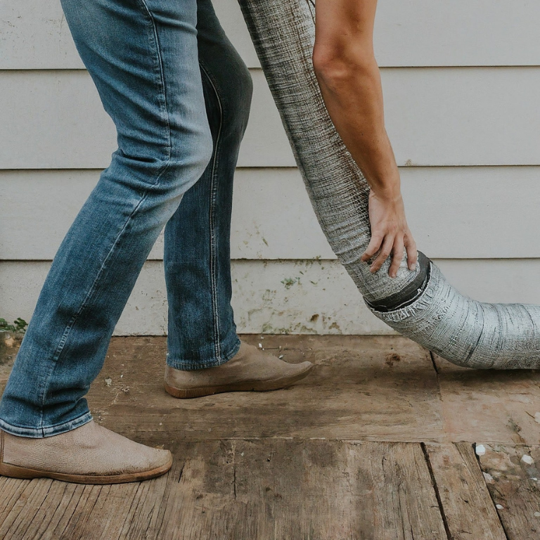 man cleaning dryer vent