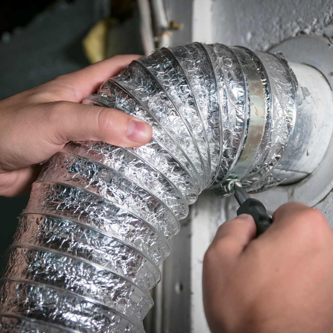 A person is fixing a duct with a pair of pliers.