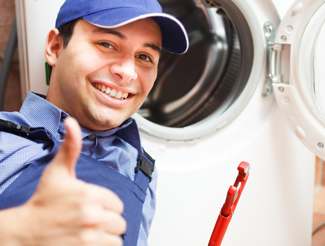 A professional cleaner/repair man fixing up a dryer