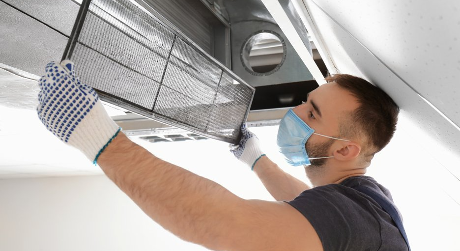 a professional removing vent to clean air ducts