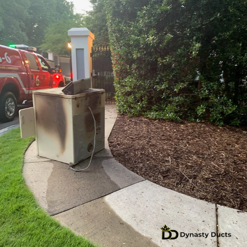 Side view of a burnt dryer with a fire truck in the background.