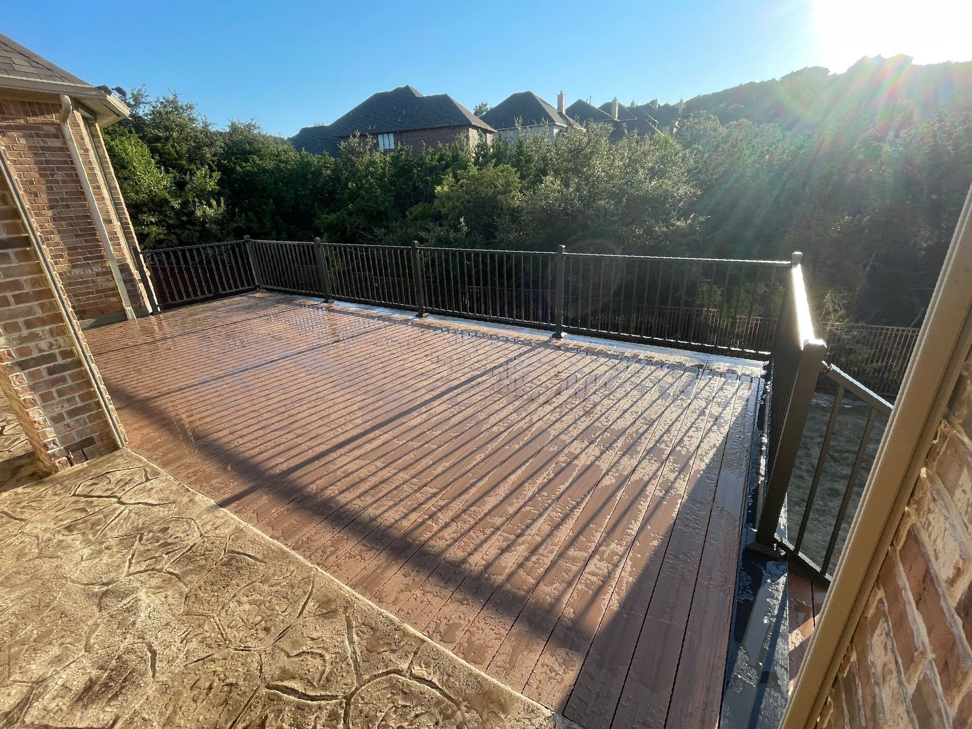 A wooden deck with a metal railing.