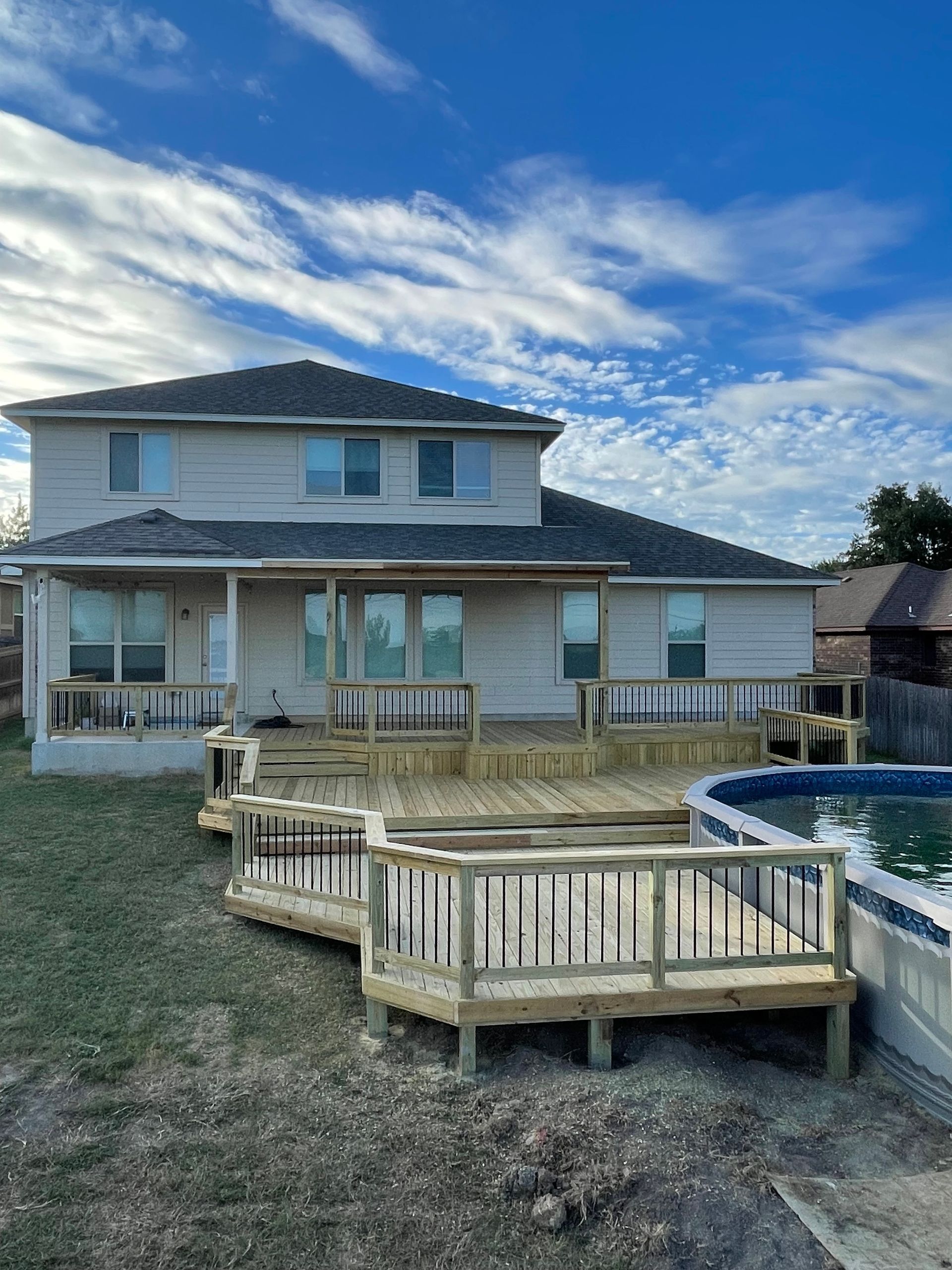pressure treated Pine pool deck in backyard