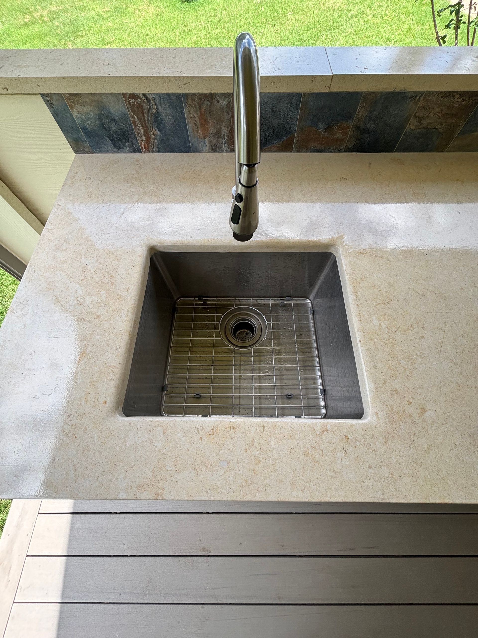 outdoor stainless steel kitchen sink with limestone countertop