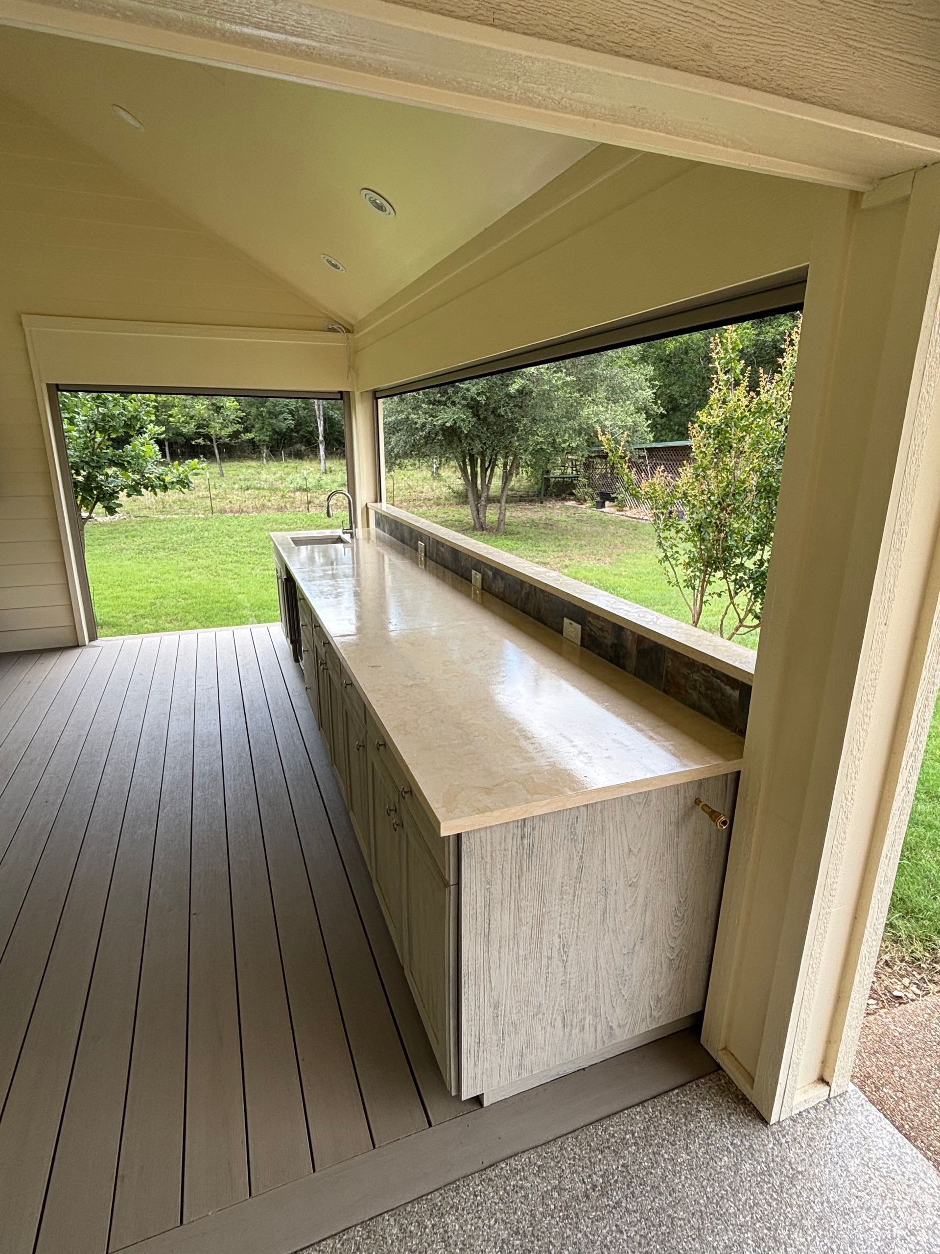 outdoor kitchen in nice back yard