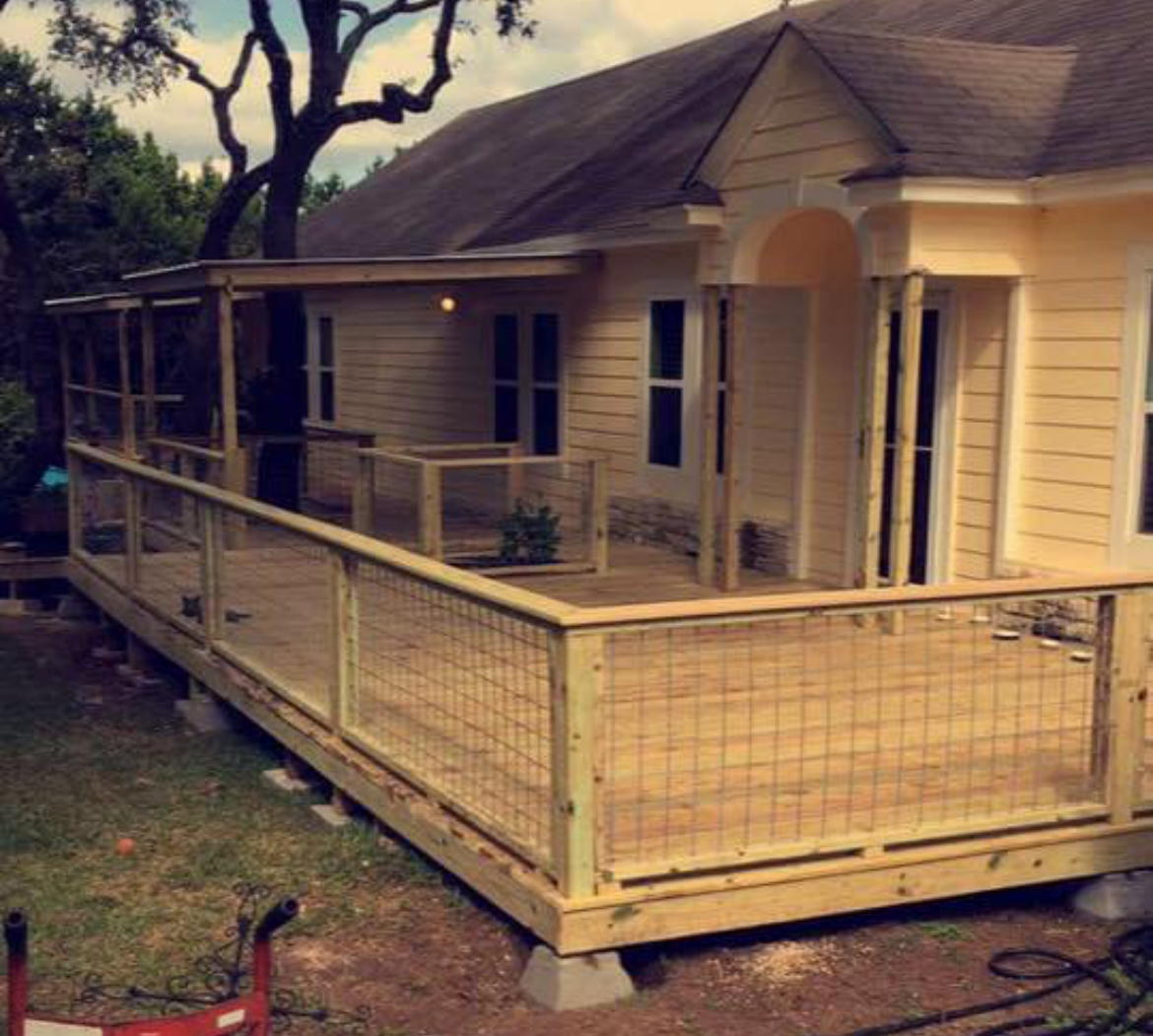 A house with a wooden deck in front of it