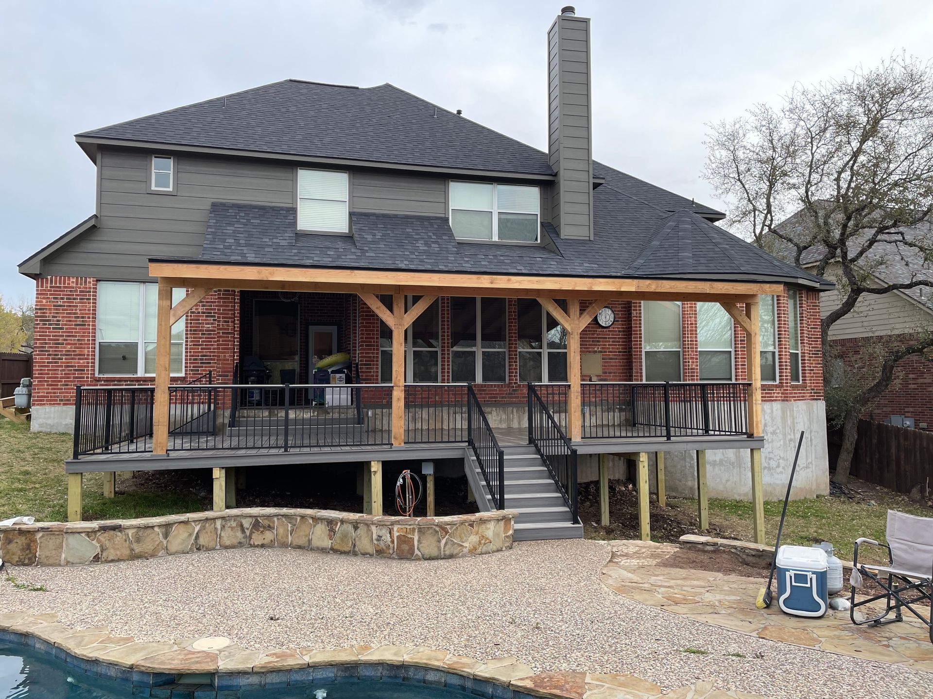 composite deck with attached roof cover and stone bench China springs tx