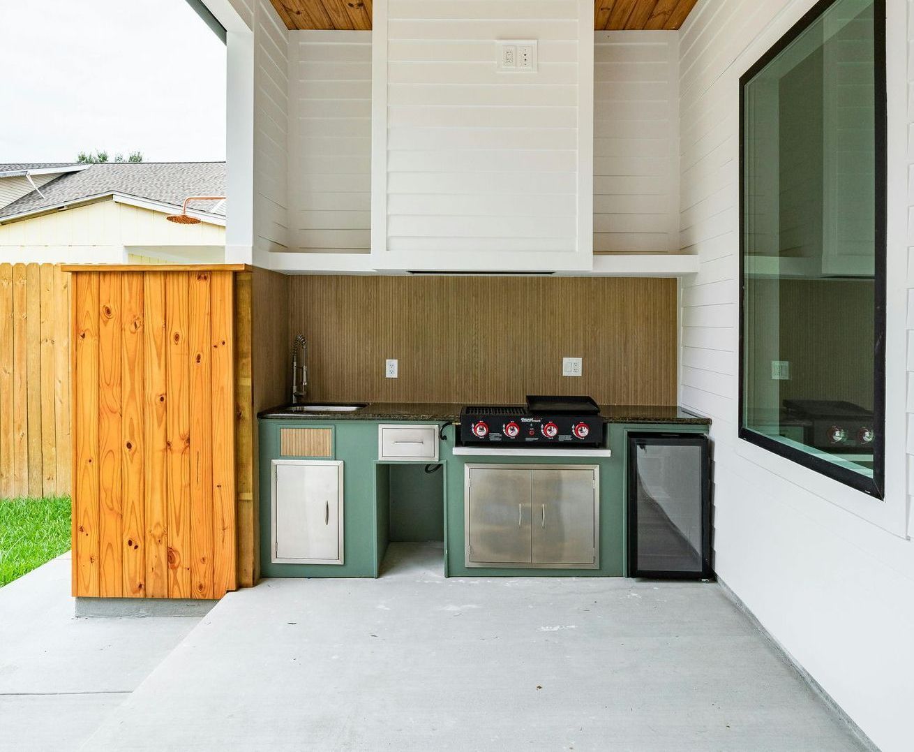 green and white outdoor kitchen setup with stainless steel
