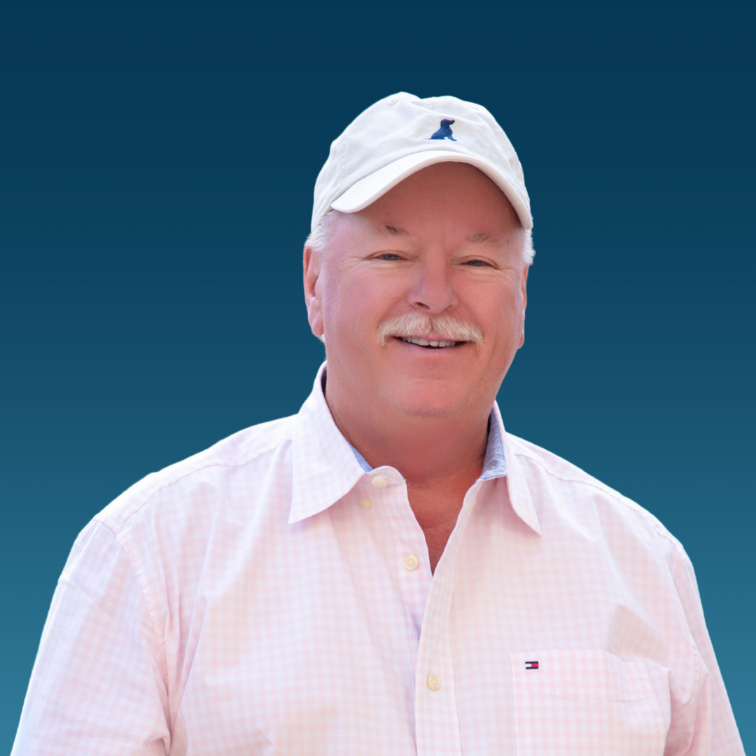 A man in a suit and tie is smiling for the camera.