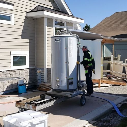 A man is working on a water heater outside of a house