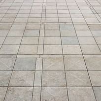 Light gray tiled pavement with grid pattern.