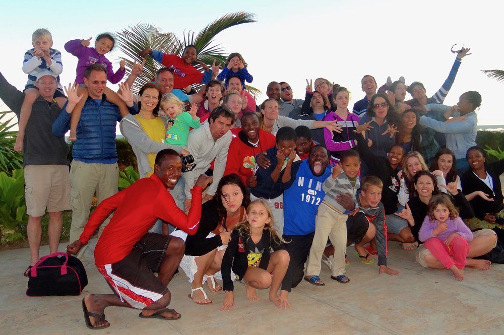 A group of people posing for a picture with one wearing a shirt that says ' abercrombie & fitch ' on it