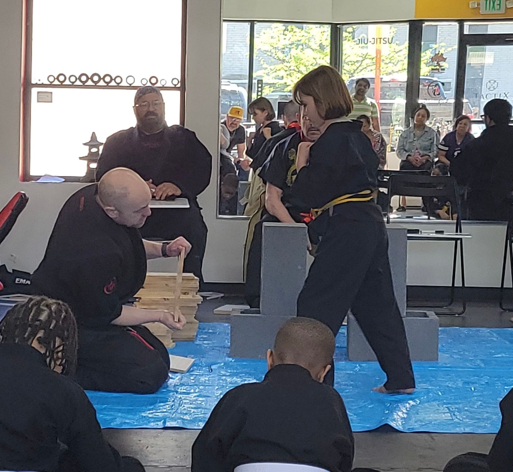 A person is holding a sparkler in their hand in the dark.