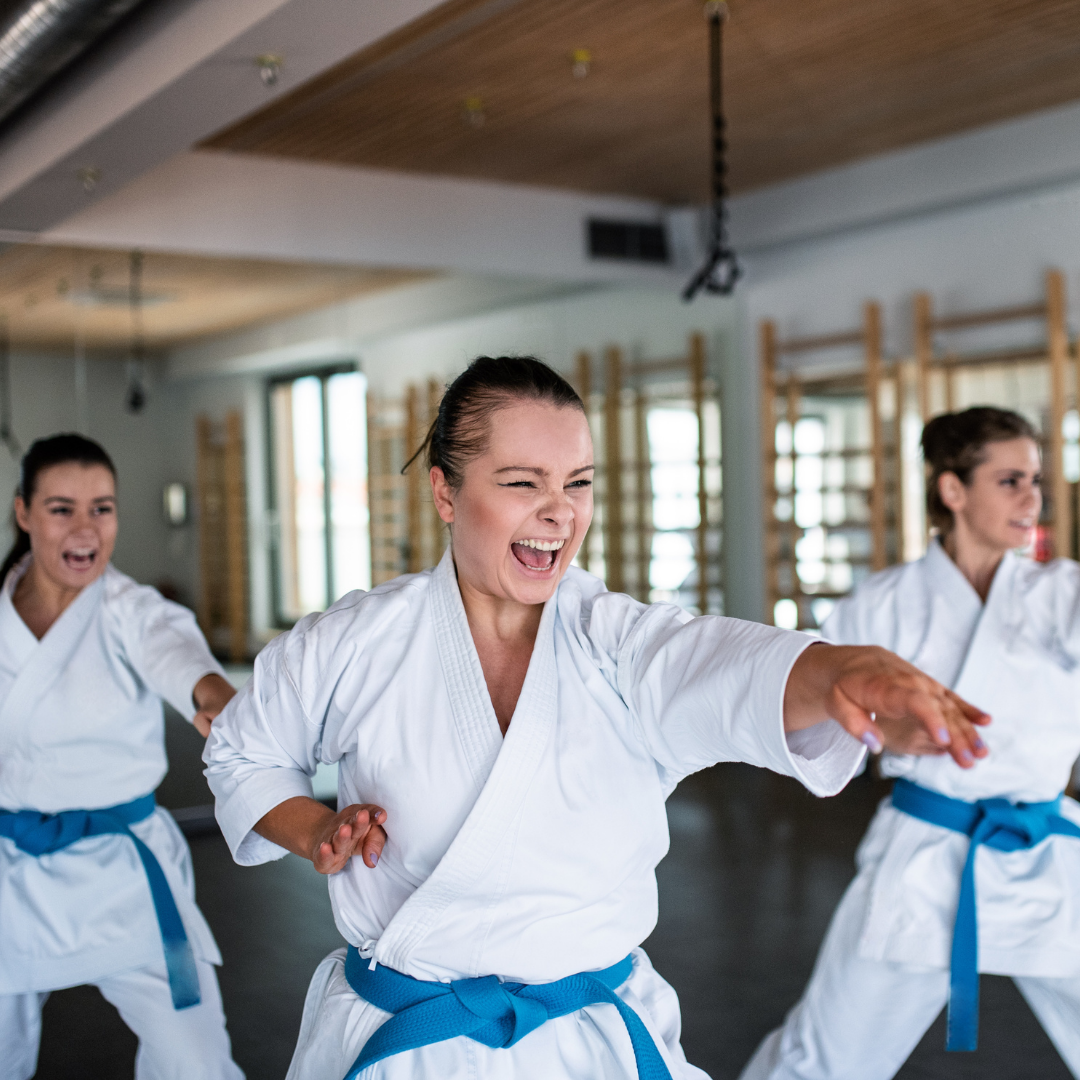 Two young men are practicing karate on a mat