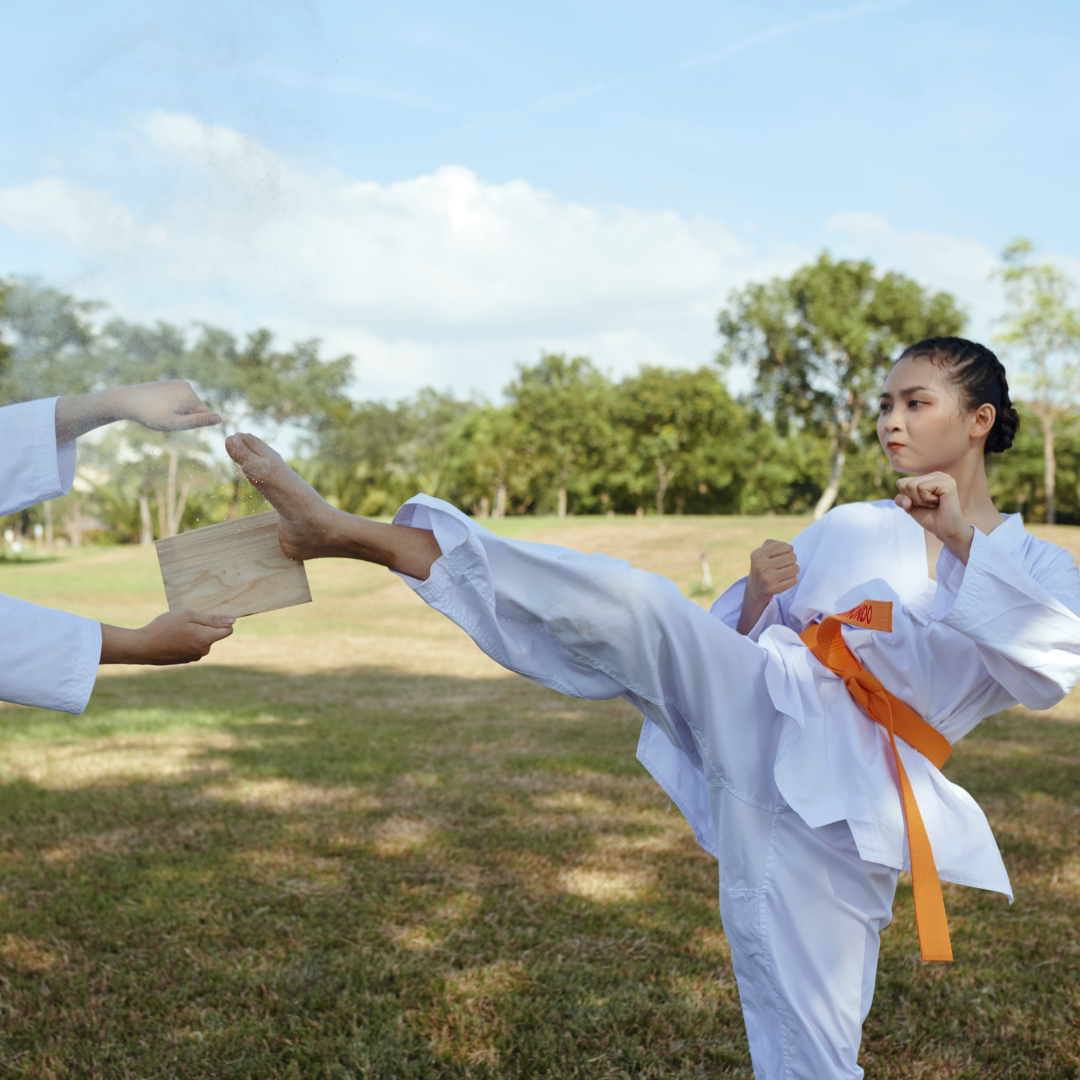 A group of men are practicing karate in a gym.