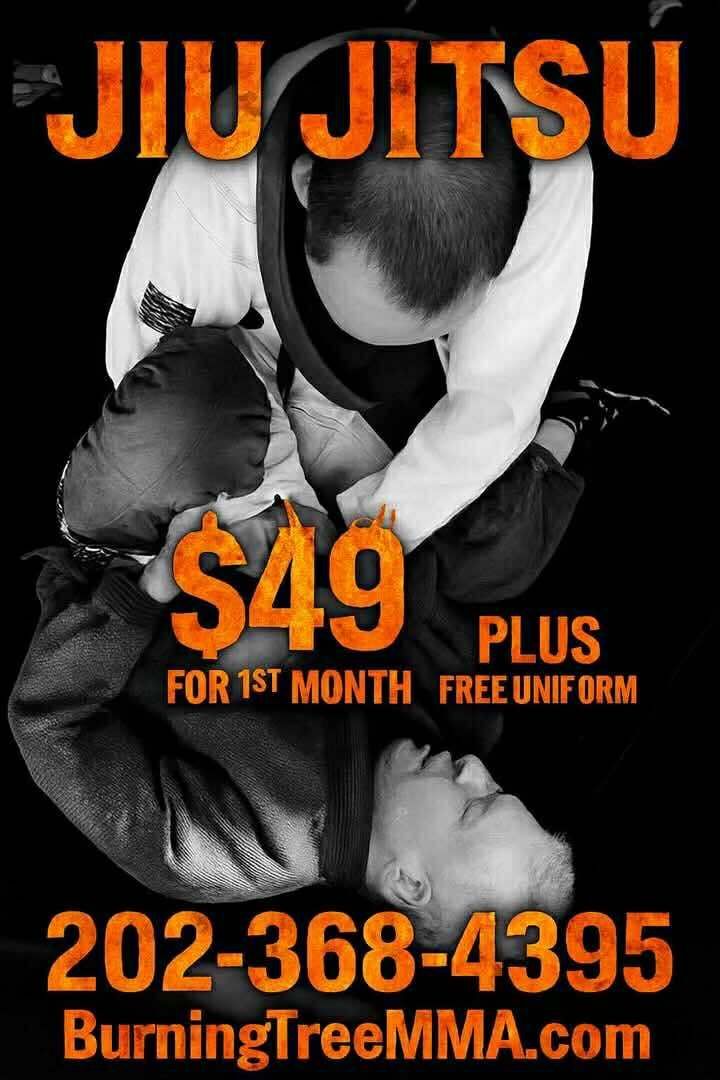 a man is laying on top of another man on a mat