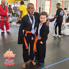 two young boys are practicing judo on a mat