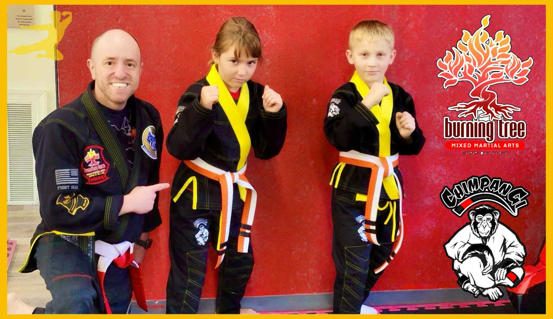 Two young boys are practicing martial arts in a dark room.