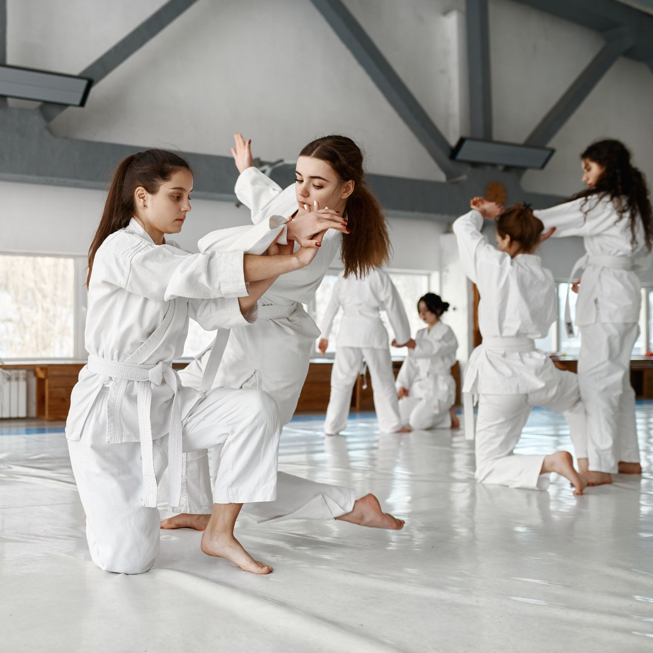 A boy and a girl are practicing taekwondo together.