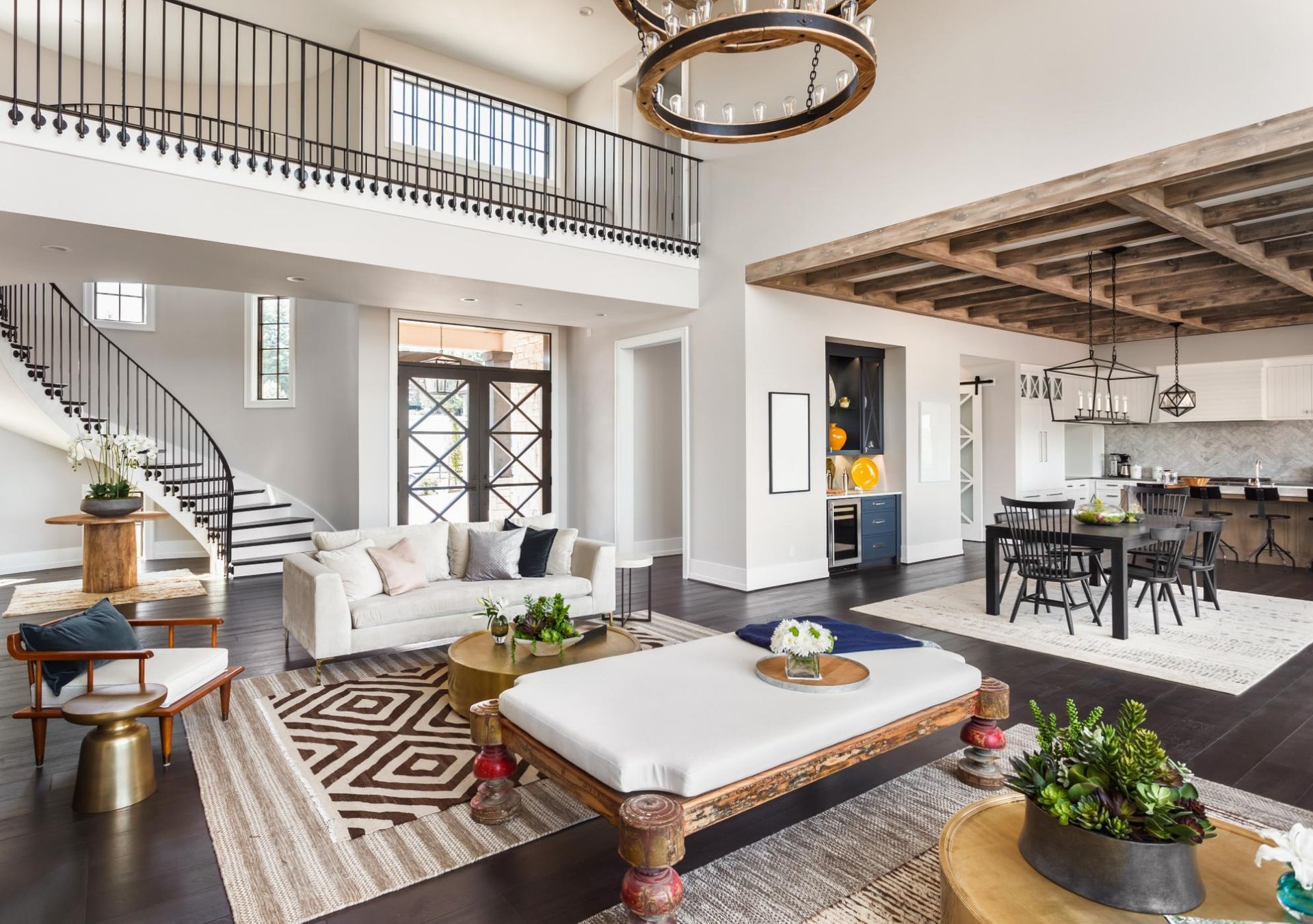 A living room filled with furniture and a staircase in a house.