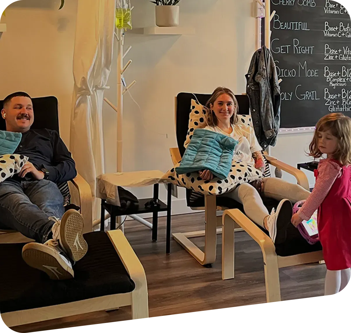 A group of people are sitting in chairs in a living room.