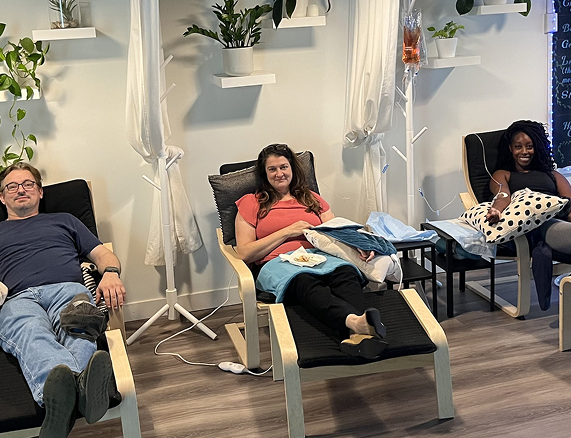 A group of people are sitting in chairs in a room.