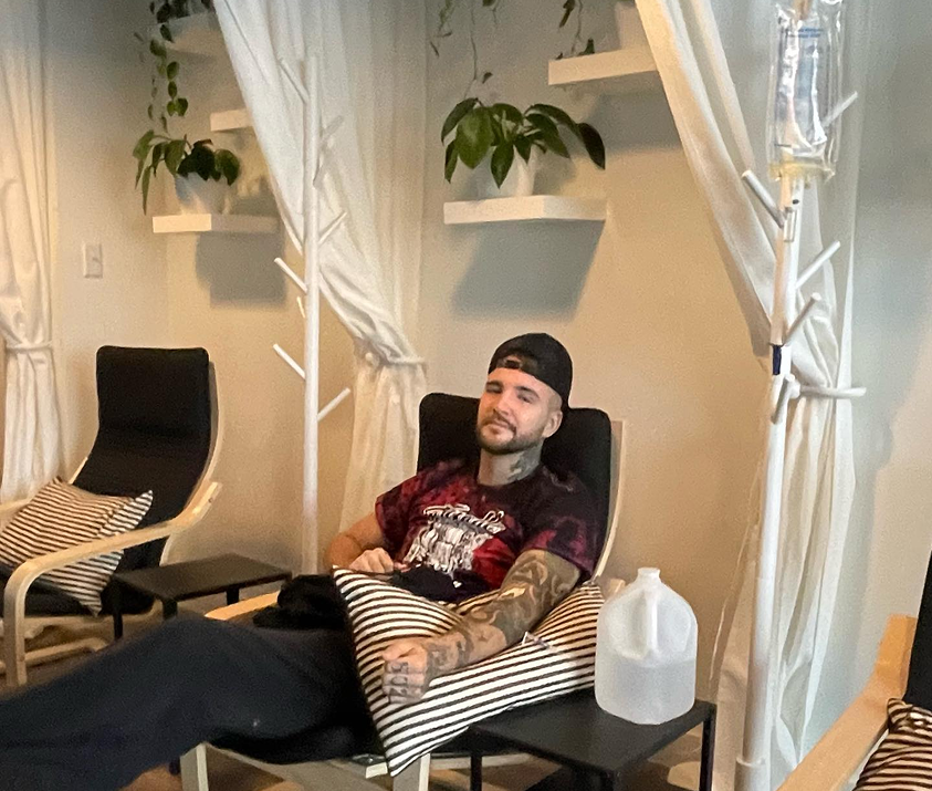 A man is sitting in a chair with his legs crossed