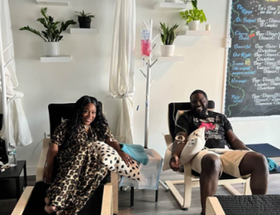 A man and a woman are sitting in chairs in a room