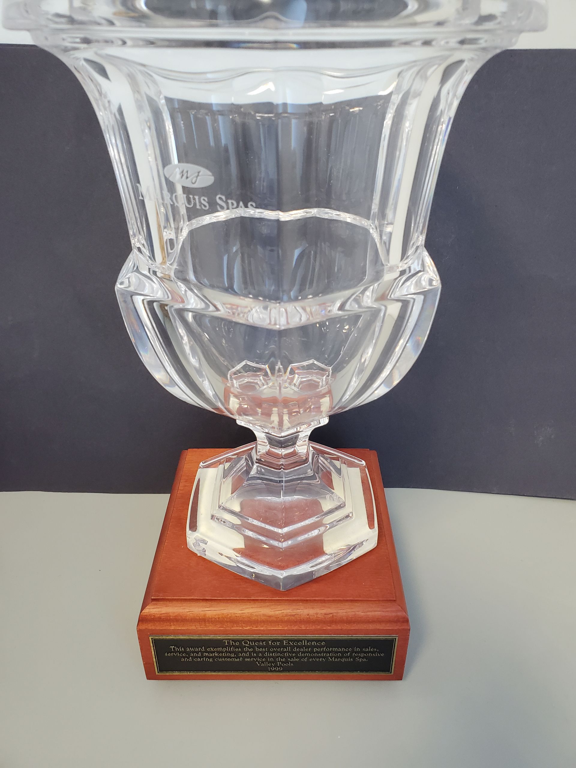 Crystal trophy on a wooden base with an engraved plate.