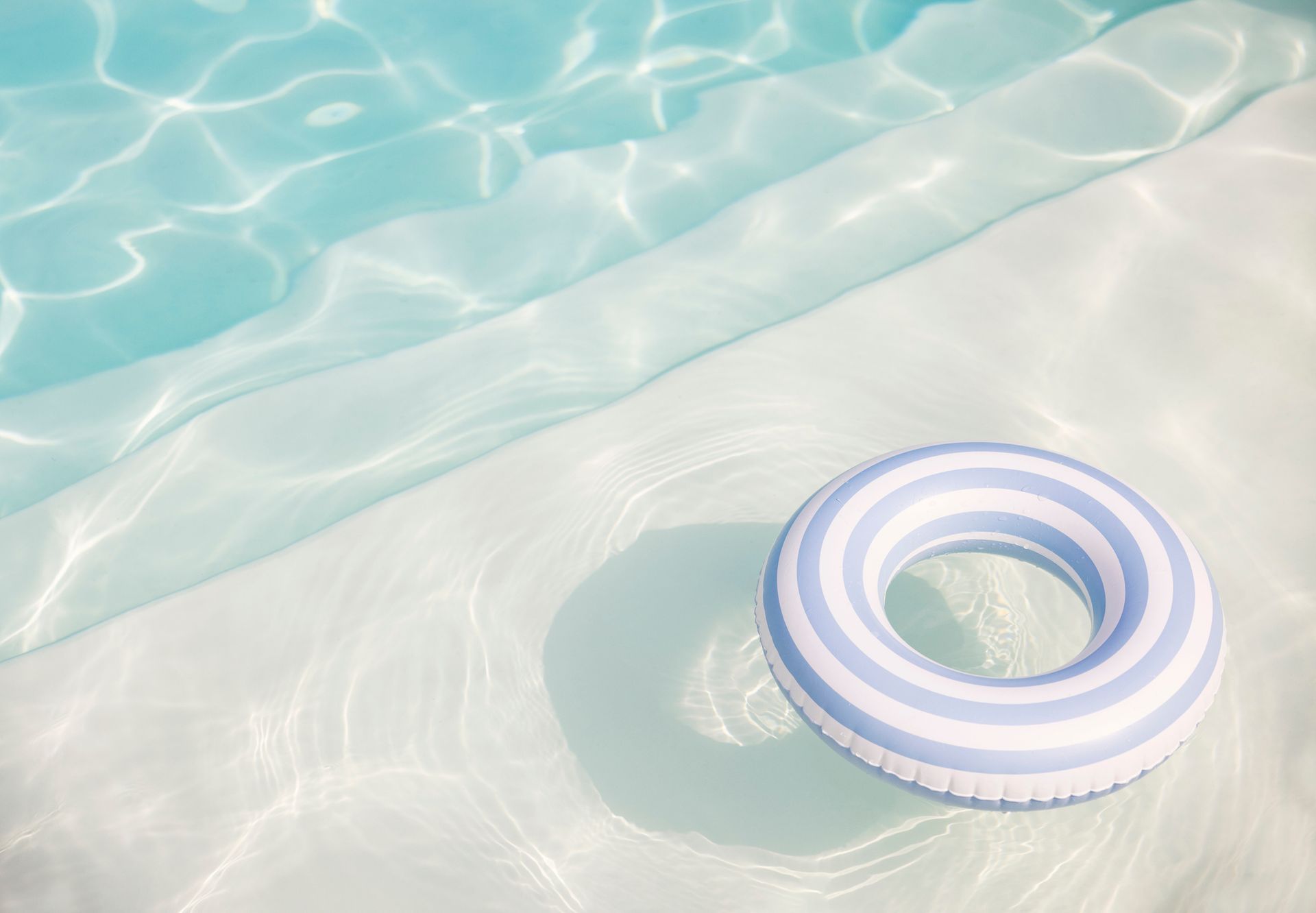 Inflatable ring floating in a swimming pool, ready for a relaxing and fun swimming experience.