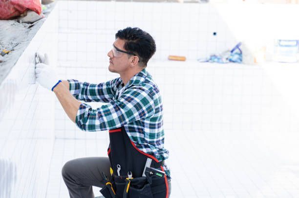 Contractor working in swimming pool under construction.