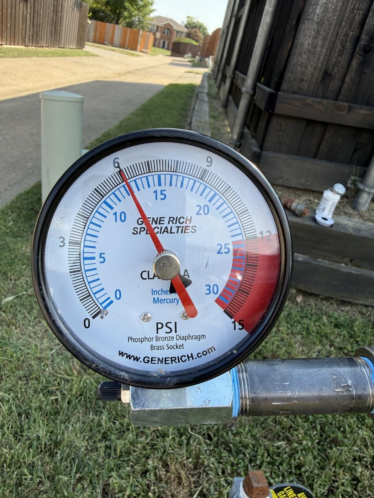 Pressure gauge reading 28 PSI, mounted outdoors.