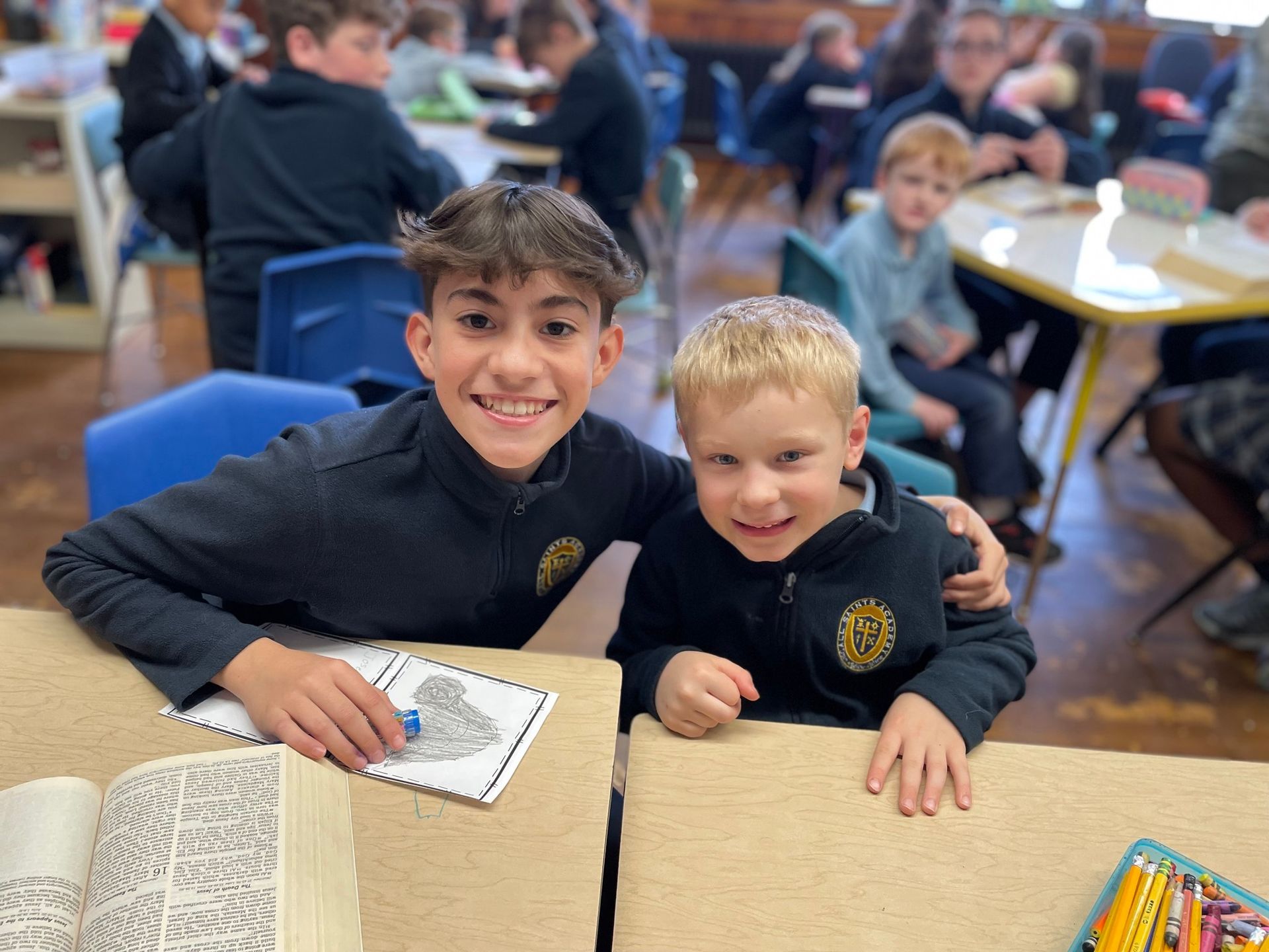 Two young boys are posing for a picture in a classroom