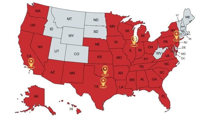 U.S. map with many states shaded red and several highlighted yellow location pins across the country