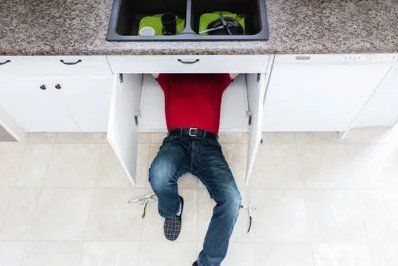 Man on the Kitchen Cabinet — Rancho Cucamonga, CA — Advanced Plumbing Solutions