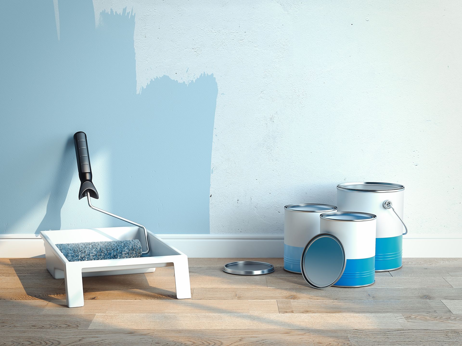 A wall being painted light blue with a roller and tray. Paint cans sit nearby.