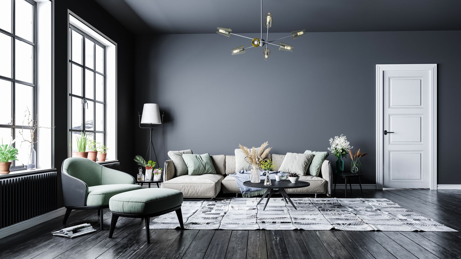 Modern living room with charcoal walls, large windows, a beige sofa, a teal chair and ottoman, and a patterned rug.