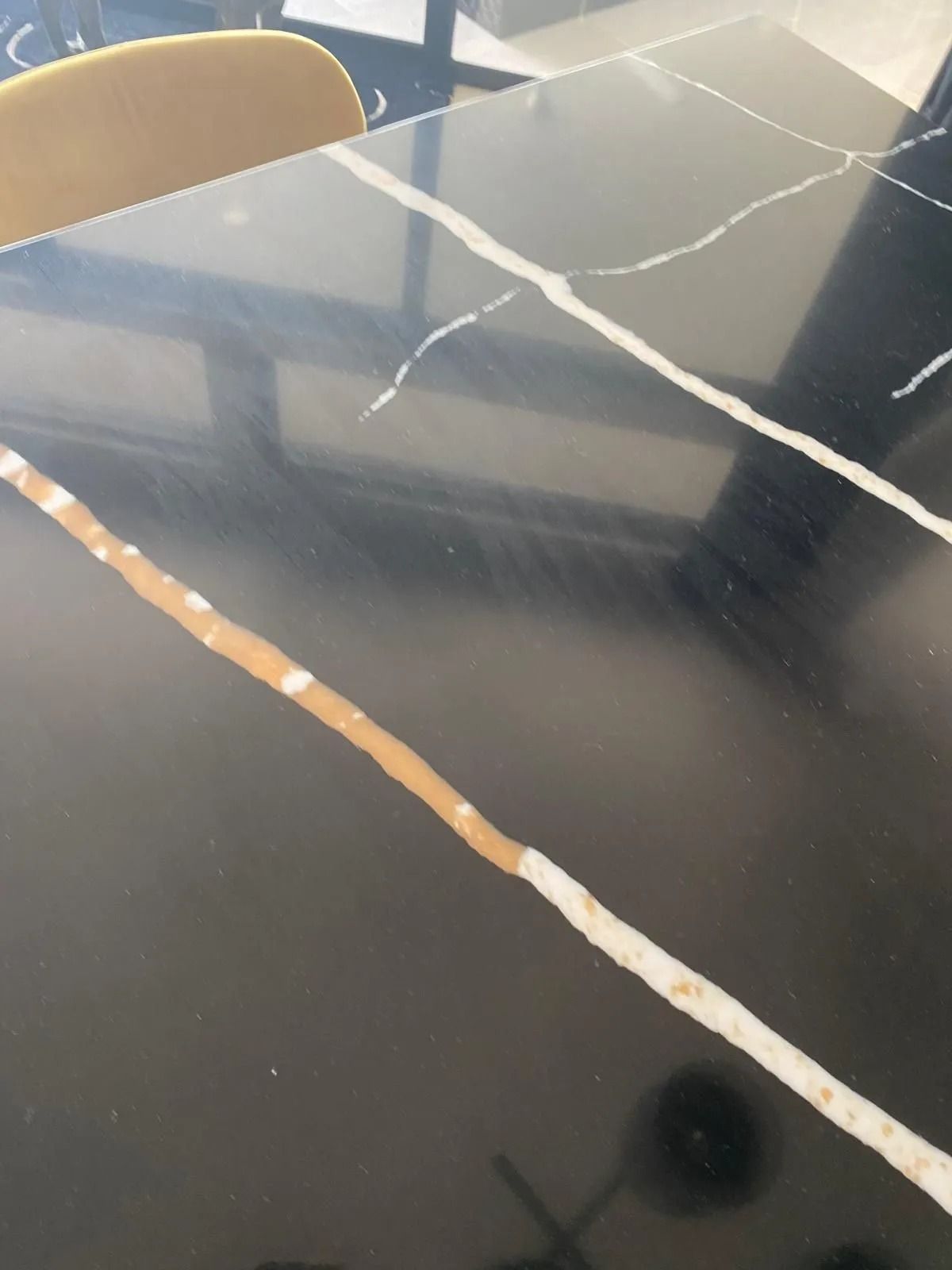 Black marble table with white and gold veining.