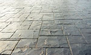 Gray stone paver flooring. Uneven rectangular shapes with visible texture.