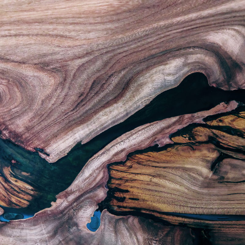 A close up of a piece of wood with a river in it.