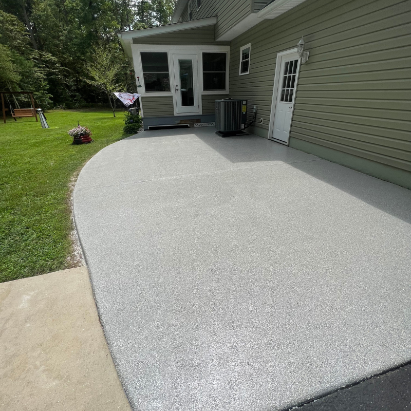 A house with a concrete patio in front of it