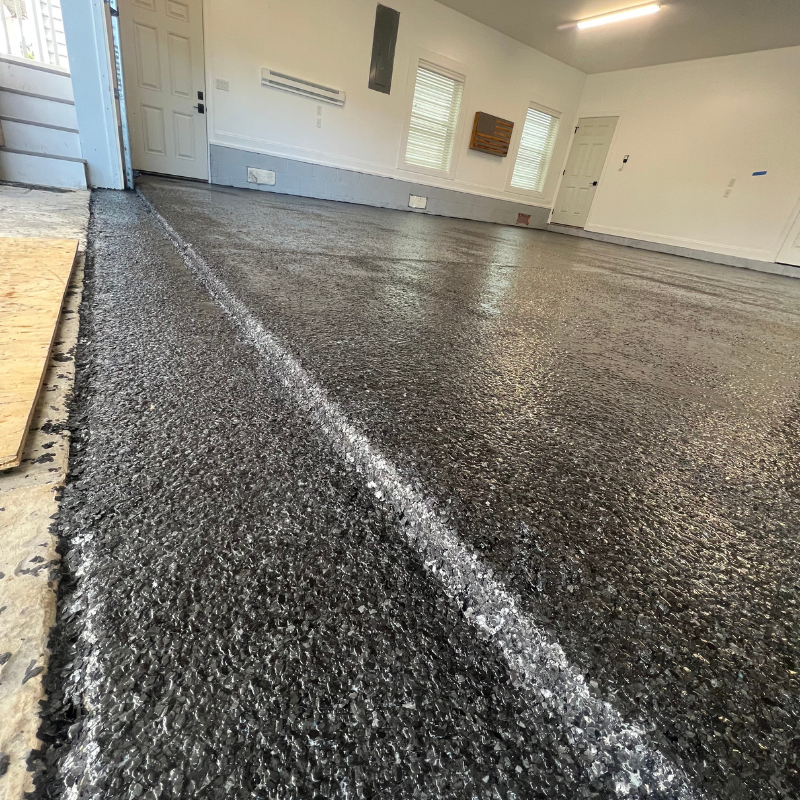 A garage floor with a white line on it.