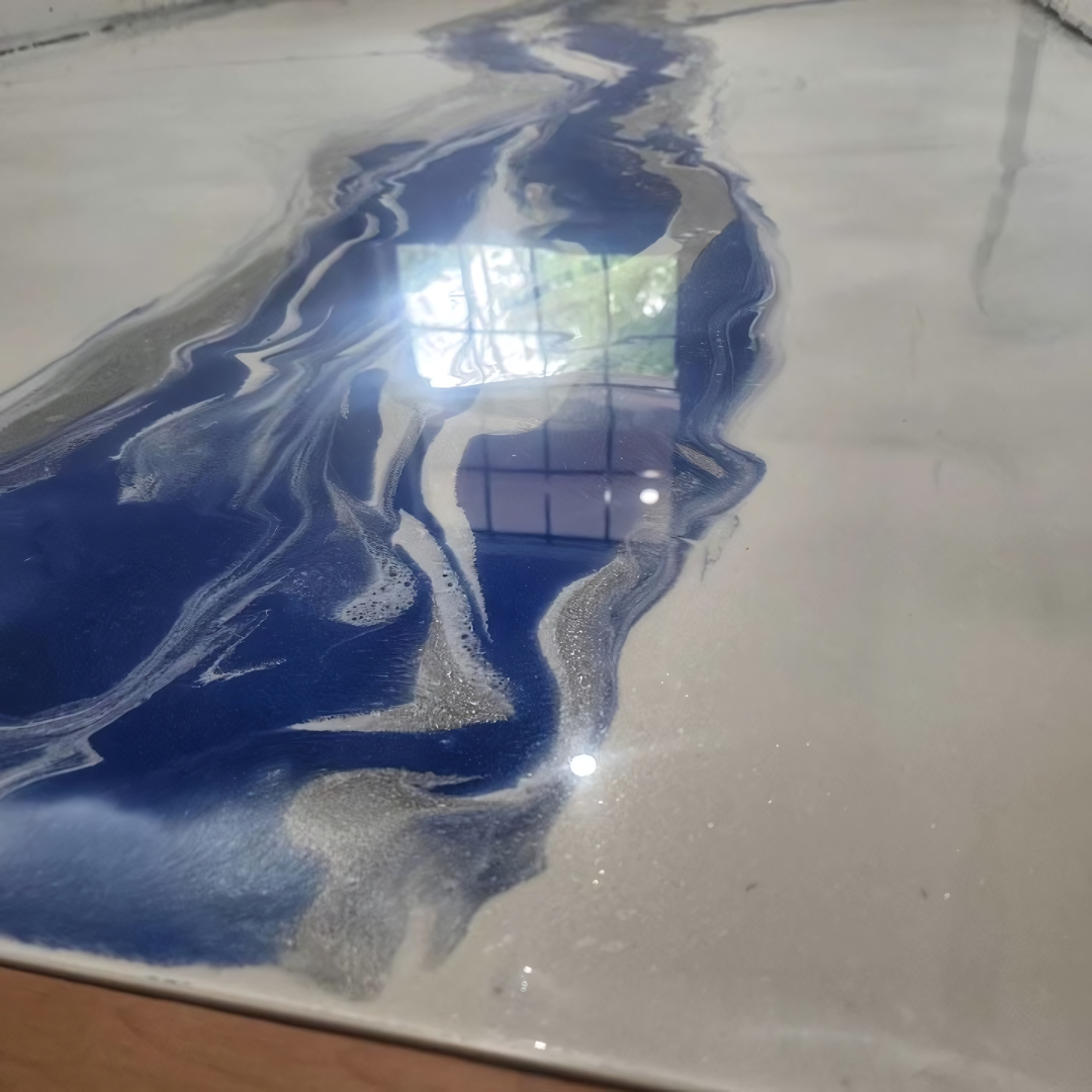 A blue and white marble floor with a reflection of a window.