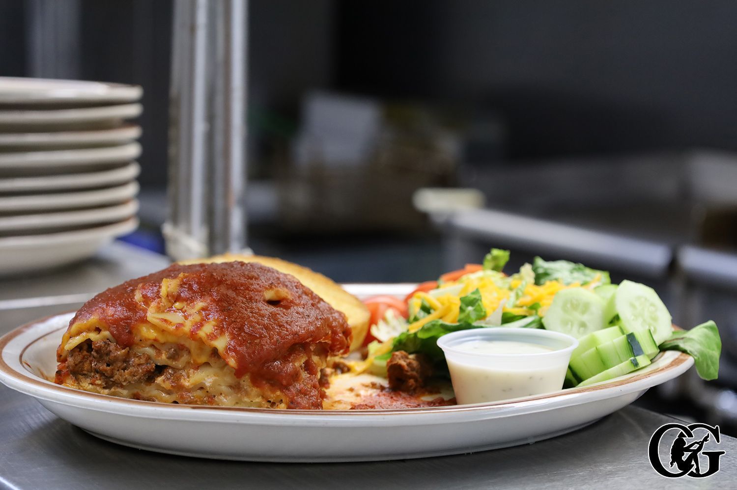 lasagna served with garlic bread and salad