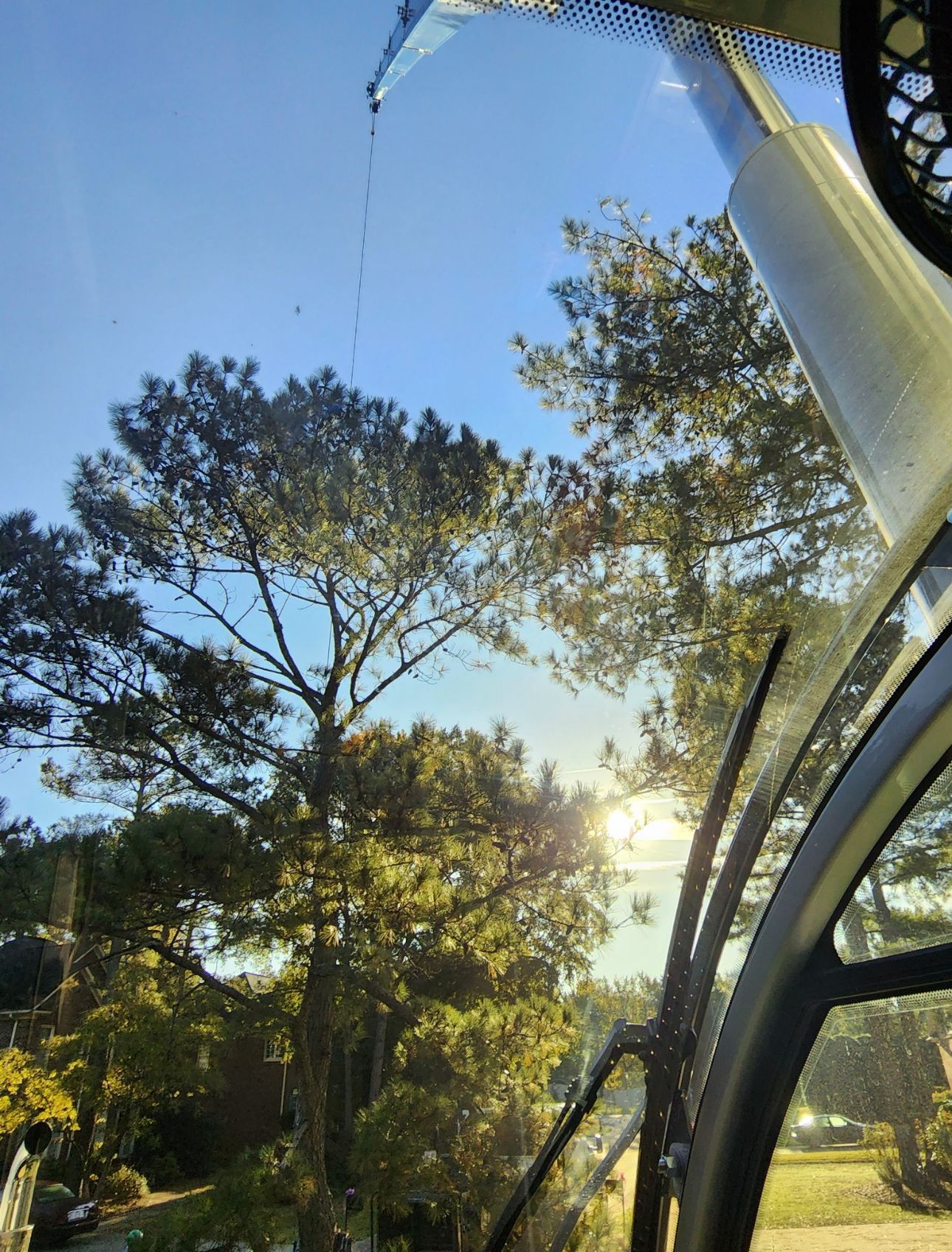 The sun is shining through the windshield of a car