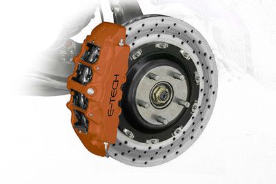 Orange E-TECH brake caliper on a slotted brake rotor with silver hardware.