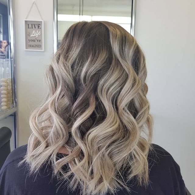 Curled Hair With Blonde Highlights — Hairdressers in Tumbi Umbi, NSW