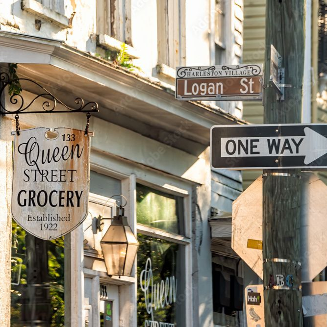 Queen Street Grocery, established in Charleston, SC in 1922, with hanging sign.