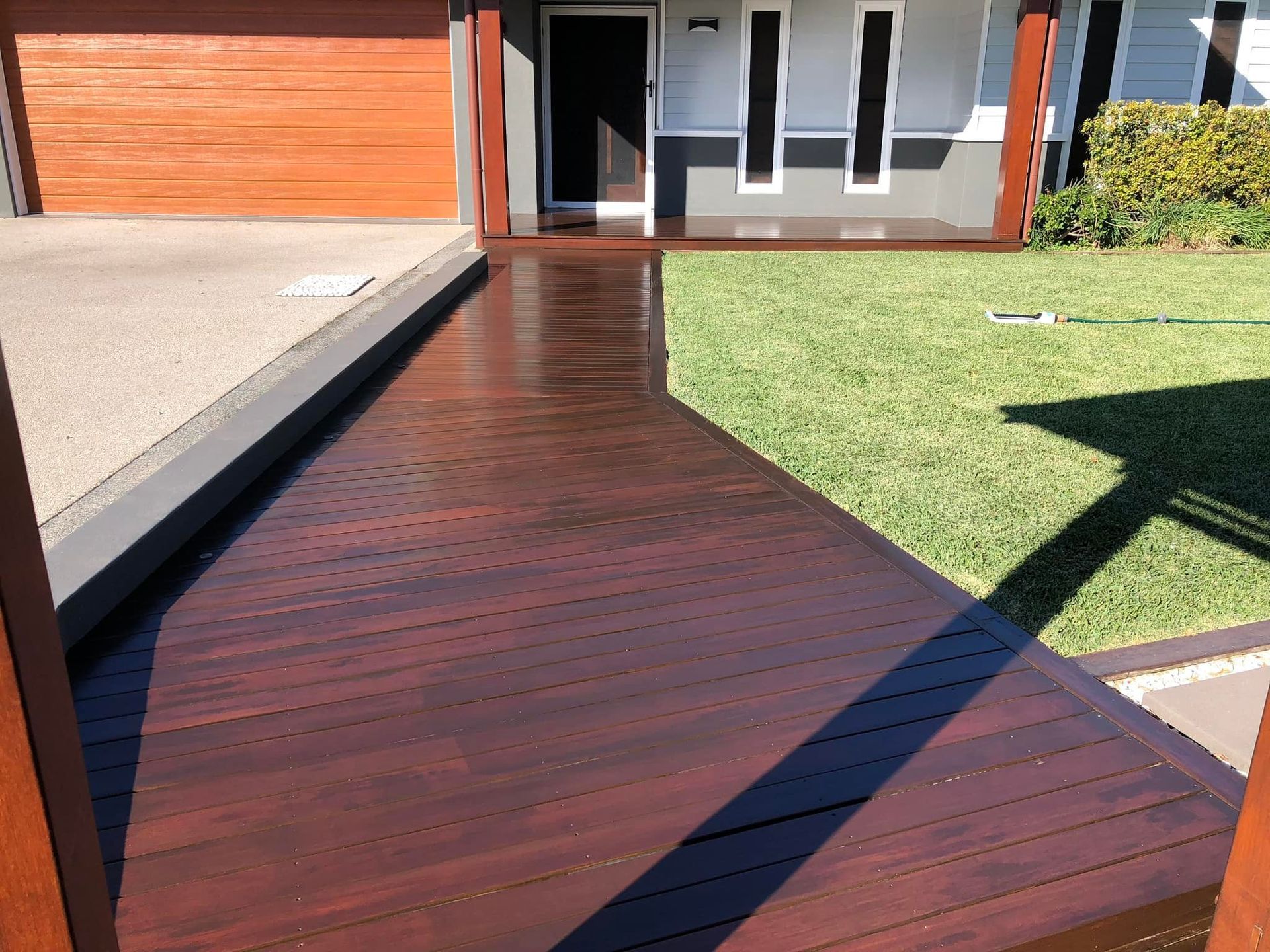 Wooden Walkway Leading To A House With A Garage — Scott Johnston Floor Sanding in Bentley Park, QLD