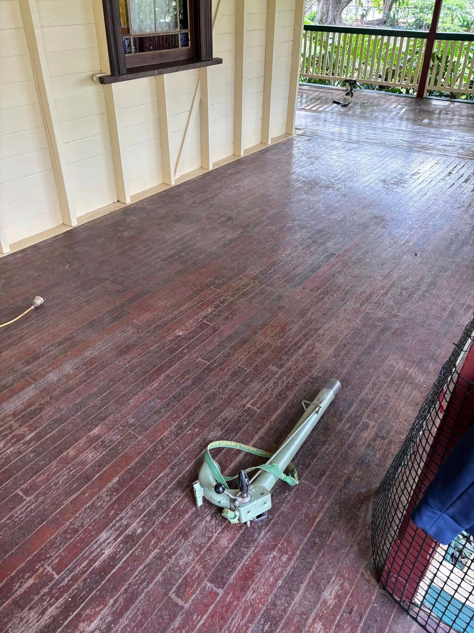 Green Metal Object on a Worn, Reddish Wooden Floor — Scott Johnston Floor Sanding in Bentley Park QLD